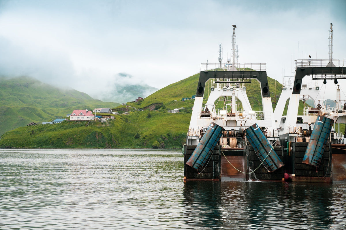 Two fishing vessels on the Alaska coast line