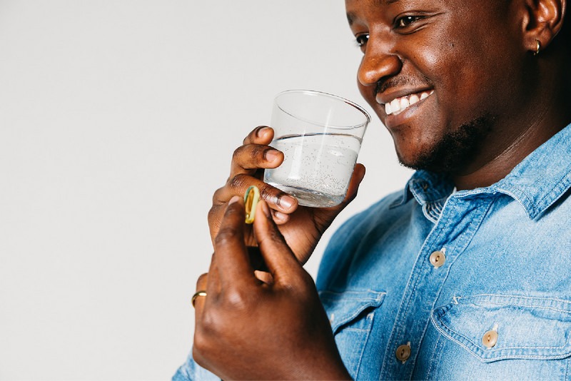 Person taking Wiley's Finest Peak EPA Omega-3 Supplement