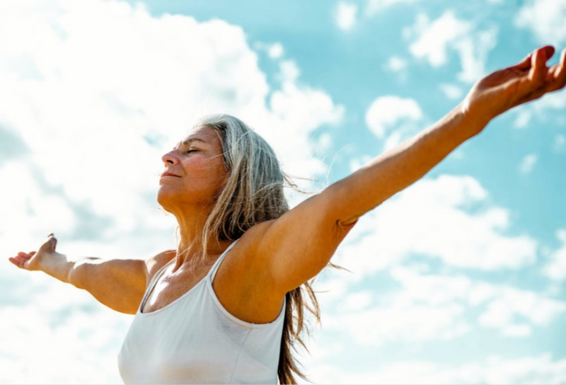 Active older woman enjoying yoga, reflecting healthy living and long-term wellness.